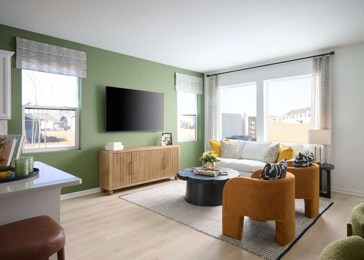 Seamless transition from Kitchen and dining to the Gathering room. Photo is of the same floorplan but is the furnished model. Design options may change- see sales for specifics.