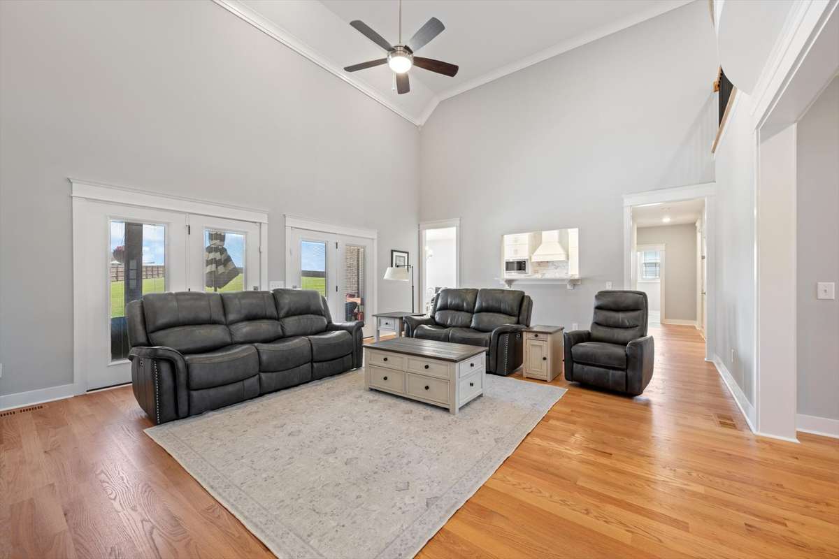 Another view of living room which opens to the kitchen and foyer.  Also has access to back porch and awesome views with the tall windows.