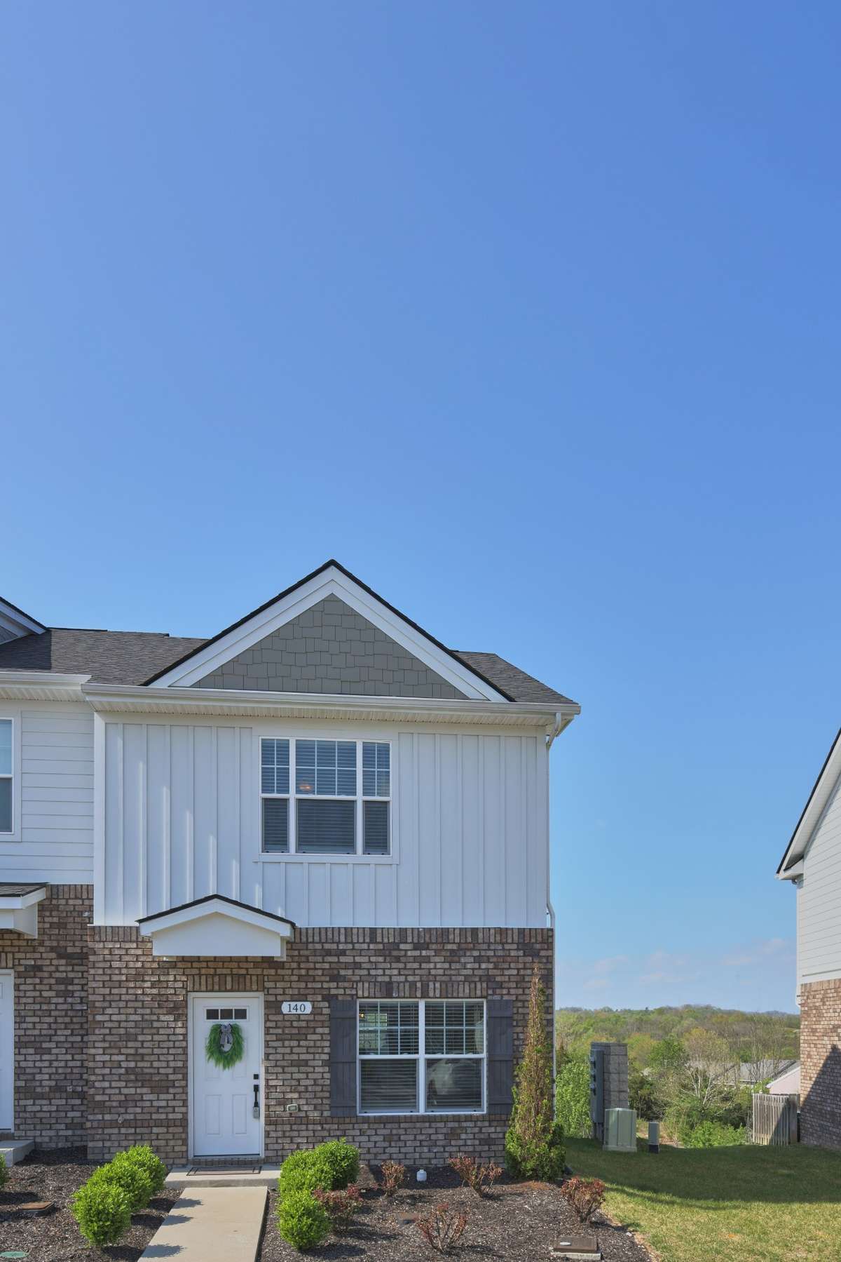 This is an end unit, with mature landscaping. It is in the finished section of the development. There is also a faucet on the front of the building, to the left of the front door, should you wish to add your own plants or pots to the front.
