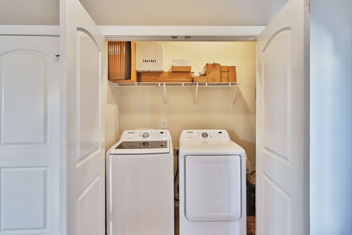All doors throughout the house are two panel with upper arch. The double doors for the lighted utility room are magnetic. Shelf above full sized washer and dryer (they remain with house!) and storage shelf above. Not shown: water heater is to right.