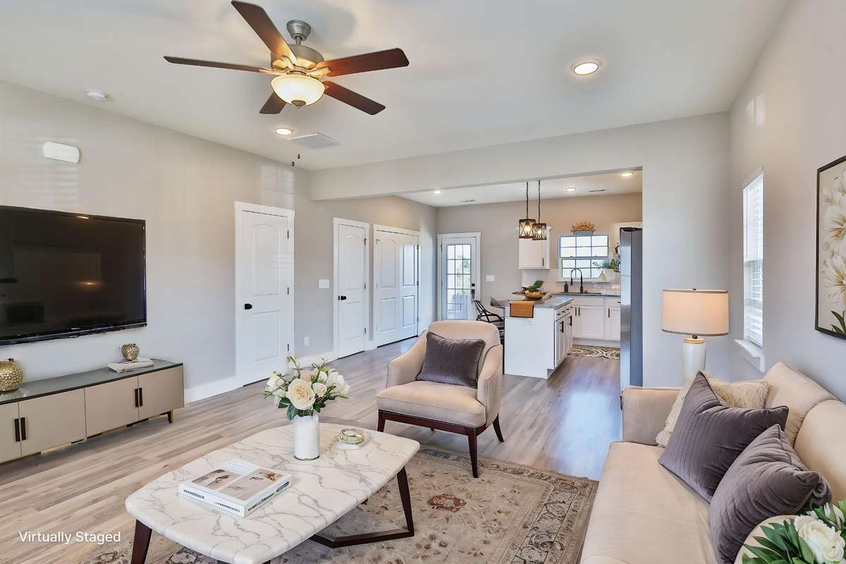 VIRTUALLY STAGED - Great room offers lots of wall space for large furniture, sectionals, extra seating. There's space for a dining table, plus seating at the breakfast bar.