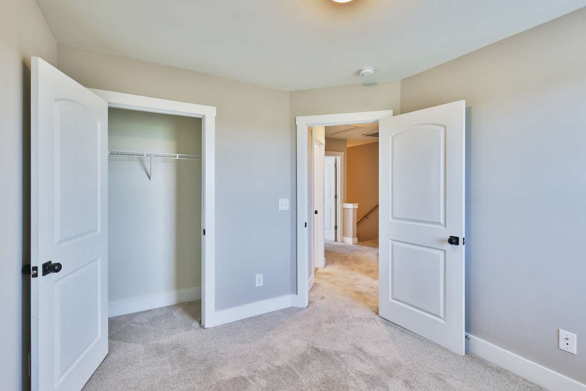 Third bedroom with view of closet and hall