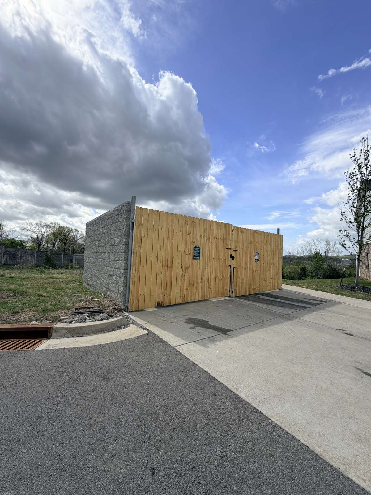 The trash collection containers have been enclosed attractively. This one is located three doors away and is very convenient to the unit.