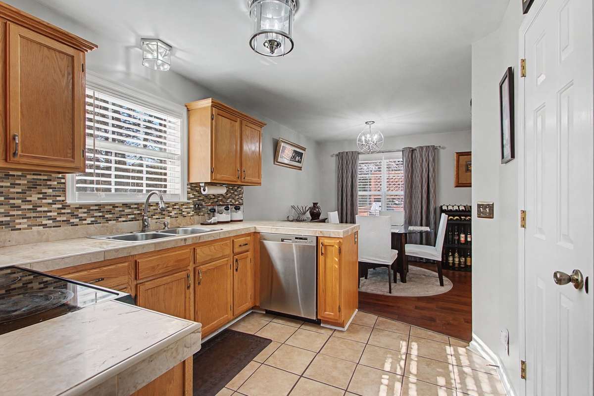 Kitchen has solid surface countertops and pantry.