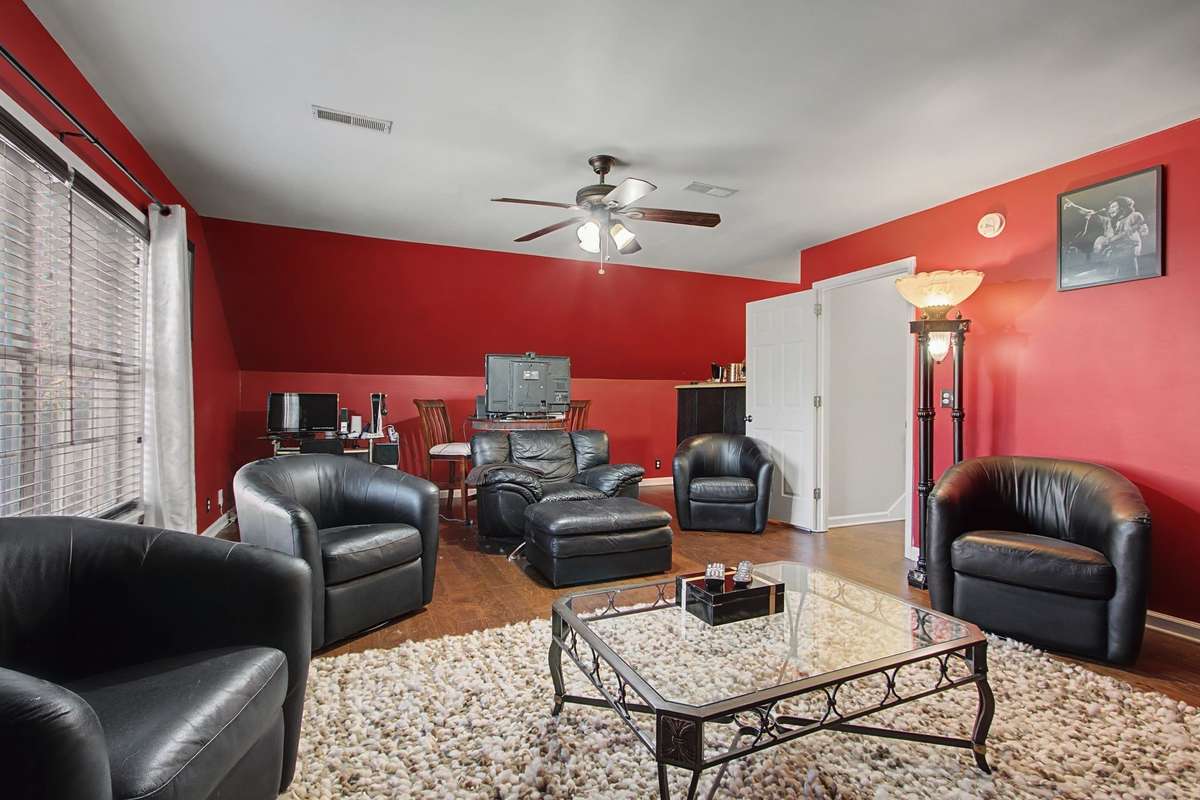 Another view of the bonus room with wood floors.