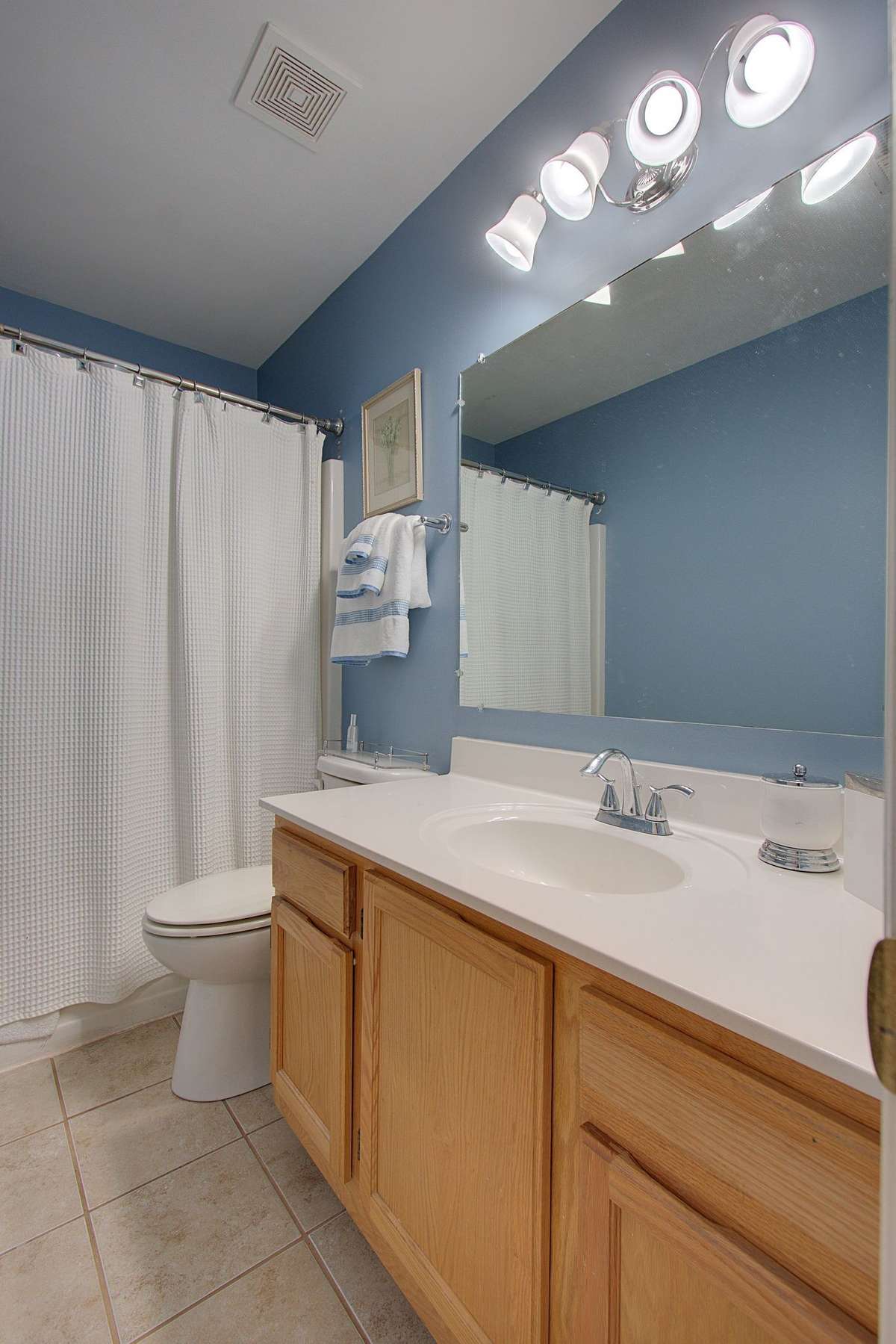 Full size bathroom with tile flooring.