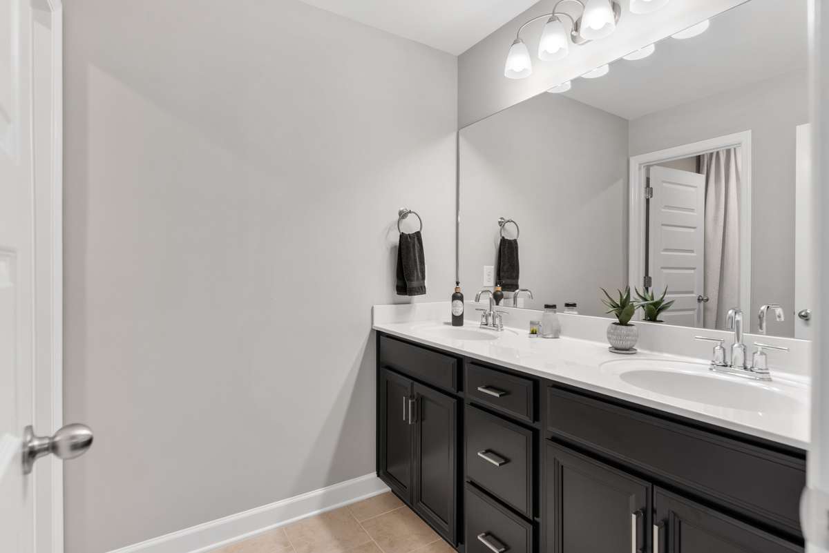 The second level offers a guest bath with separate tub/shower and vanities for maximum function.