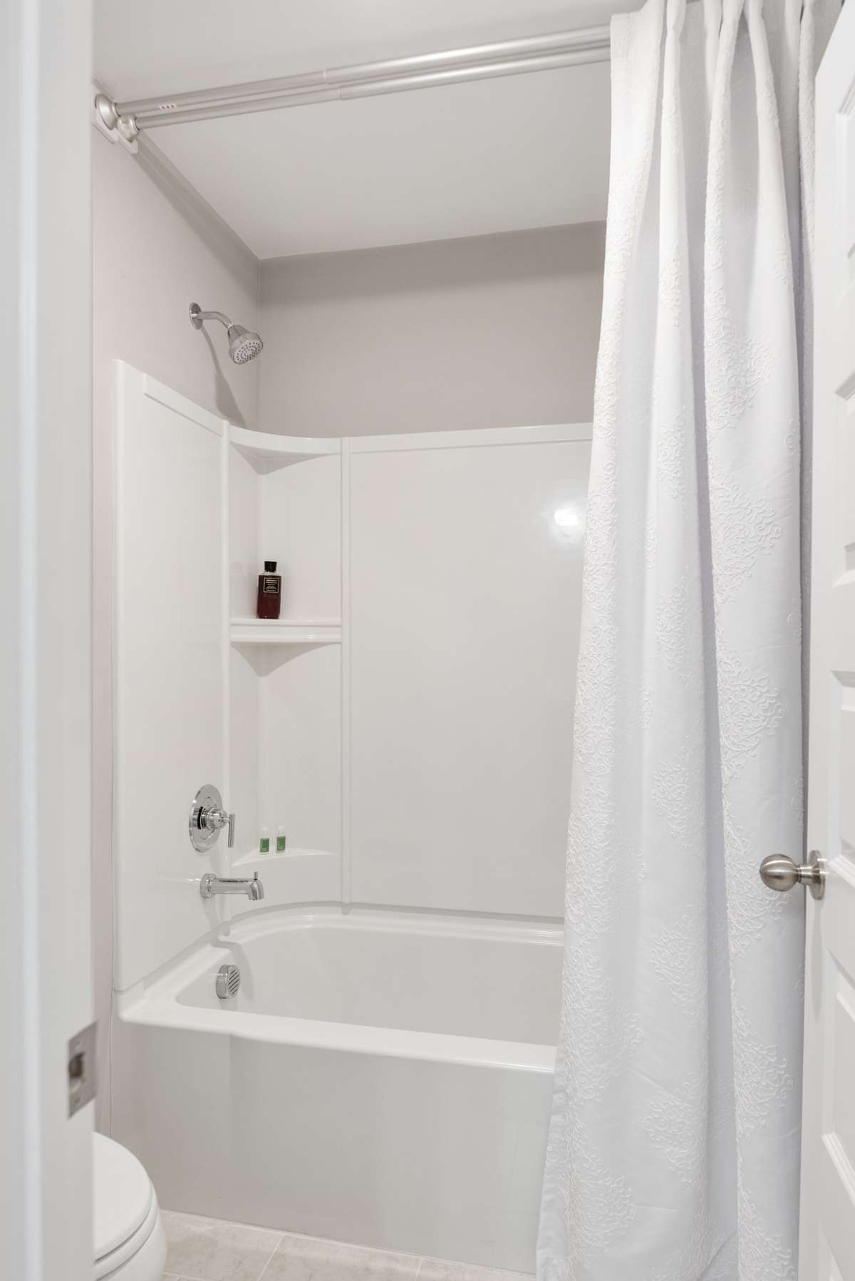 Second level shower/tub combo with tile flooring.
