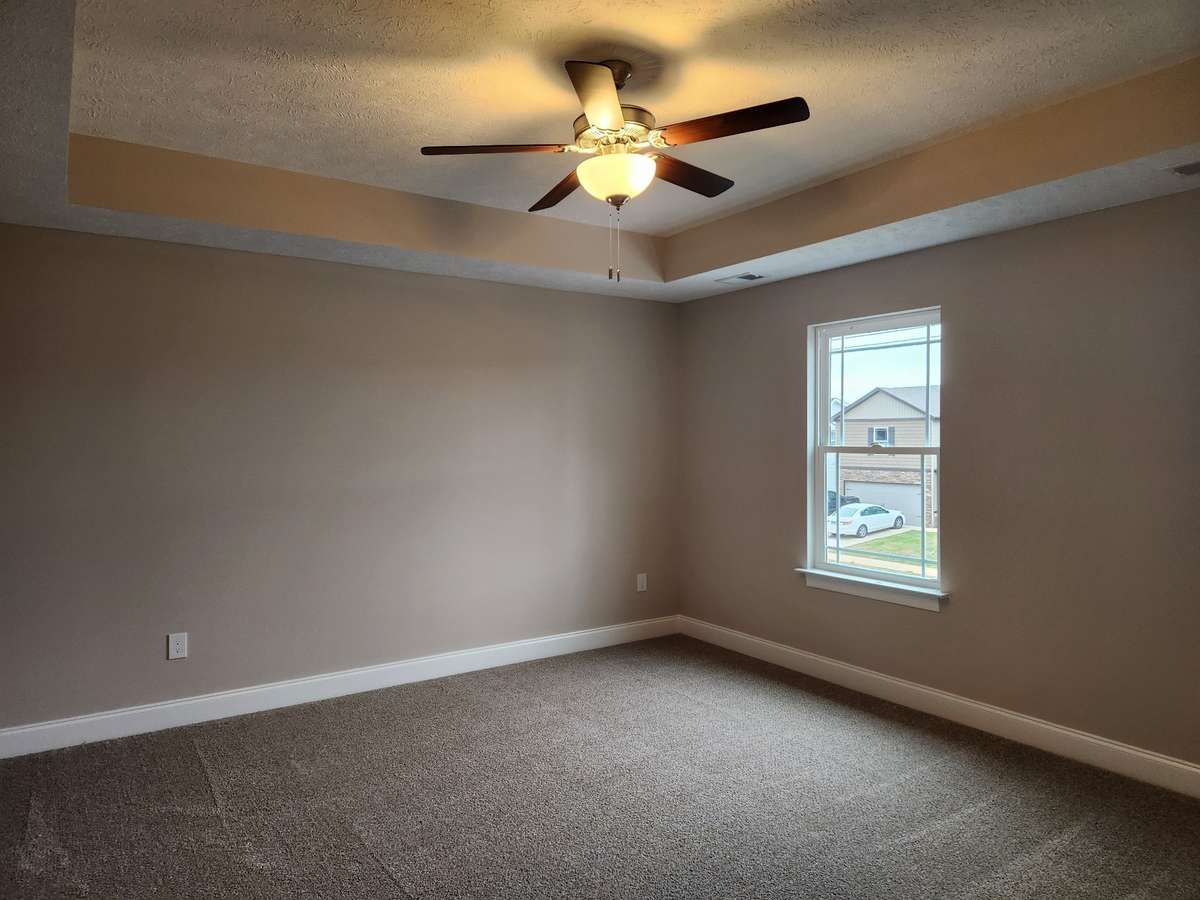 Large Owner's Suite with Trey Ceiling and Ceiling Fan.