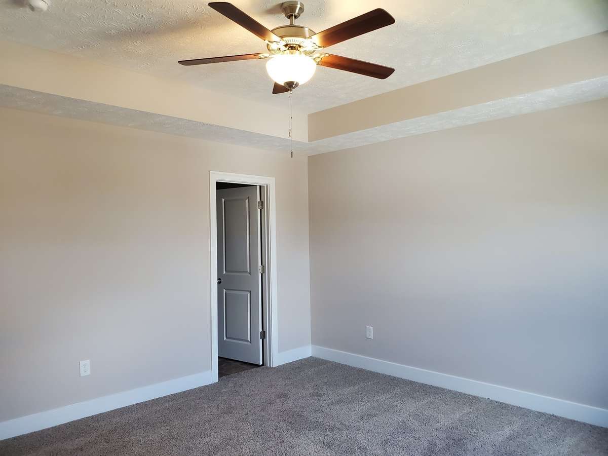 Large Owner's Suite has a Trey Ceiling and Ceiling Fan.