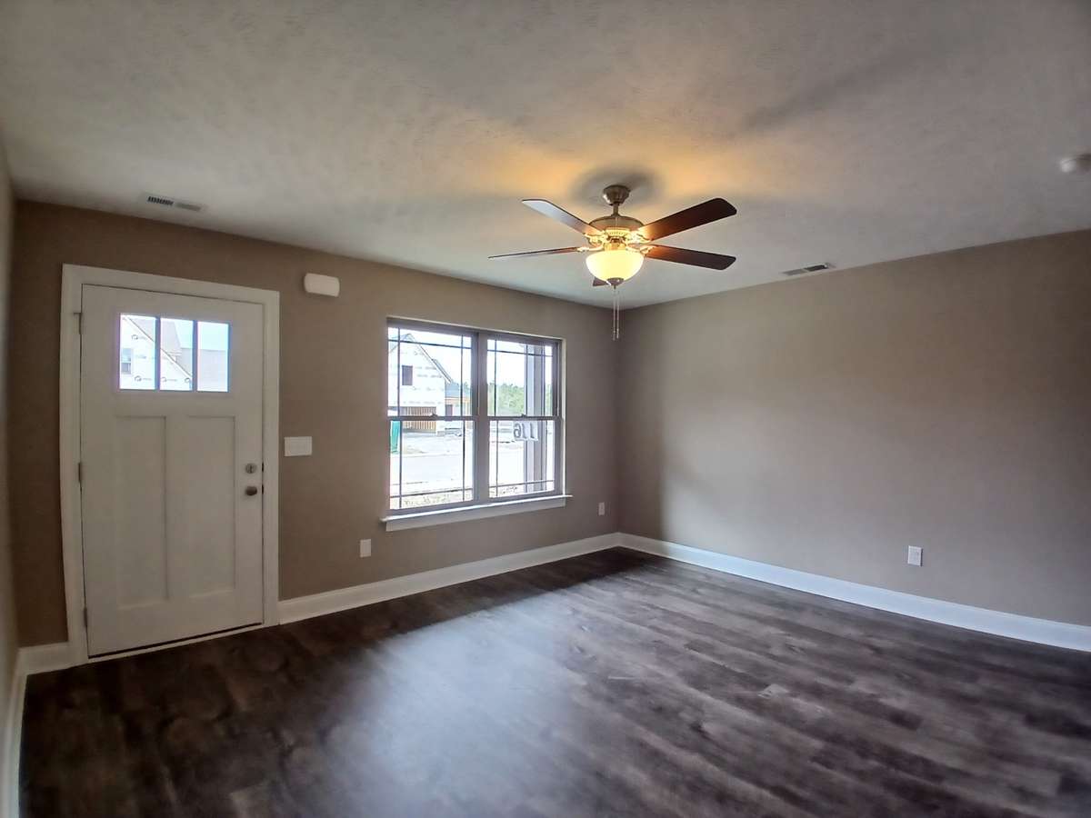 Spacious Living Room with LV Plank Flooring and Ceiling Fan.