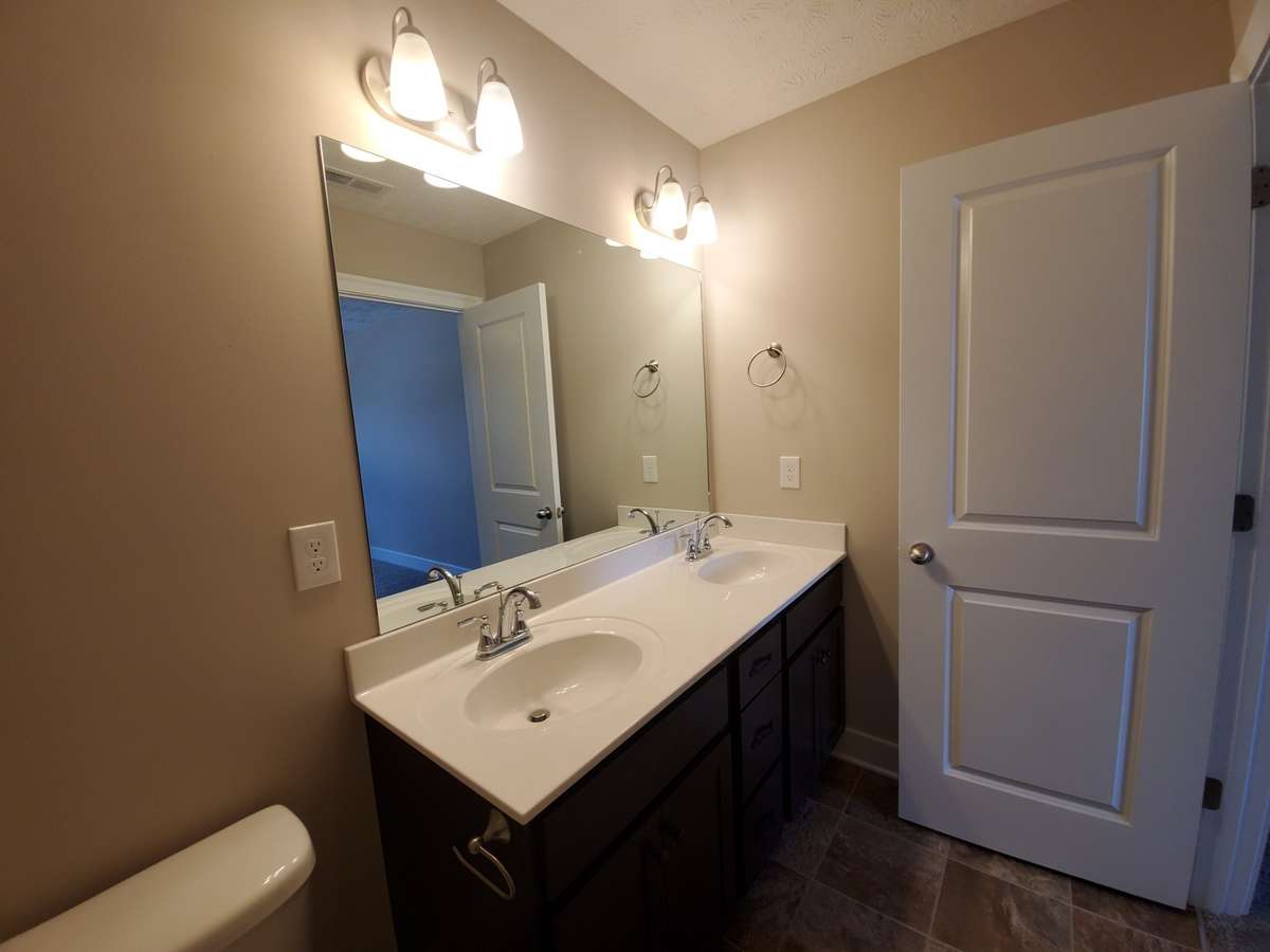 Owner's Suite features Double Sinks and Custom Cabinets. 
Picture of Similar House.