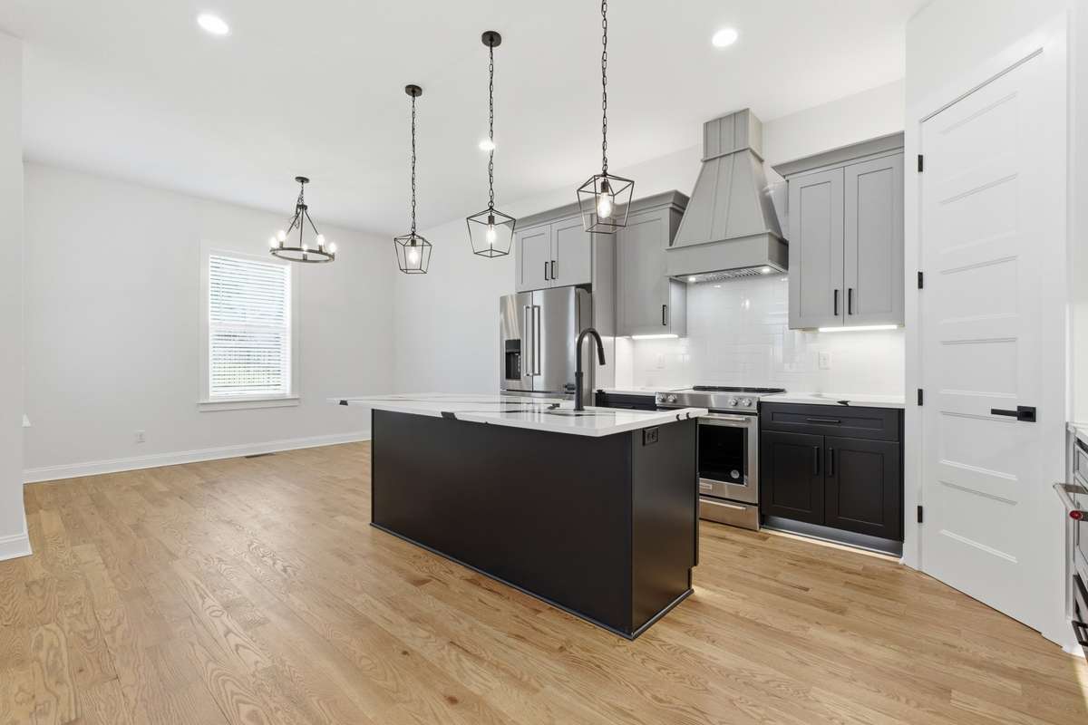 Hood in the kitchen with tile backsplash.