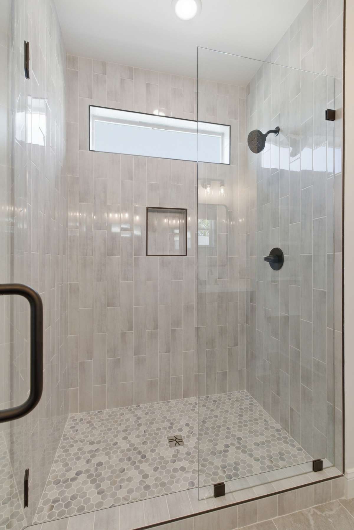 Tiled walk in shower with frameless glass.