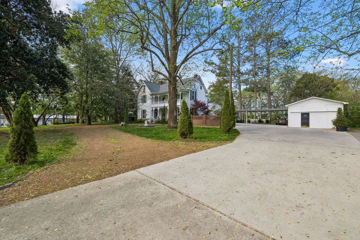 The primary driveway is concrete, but also has a circular pea gravel drive in front!