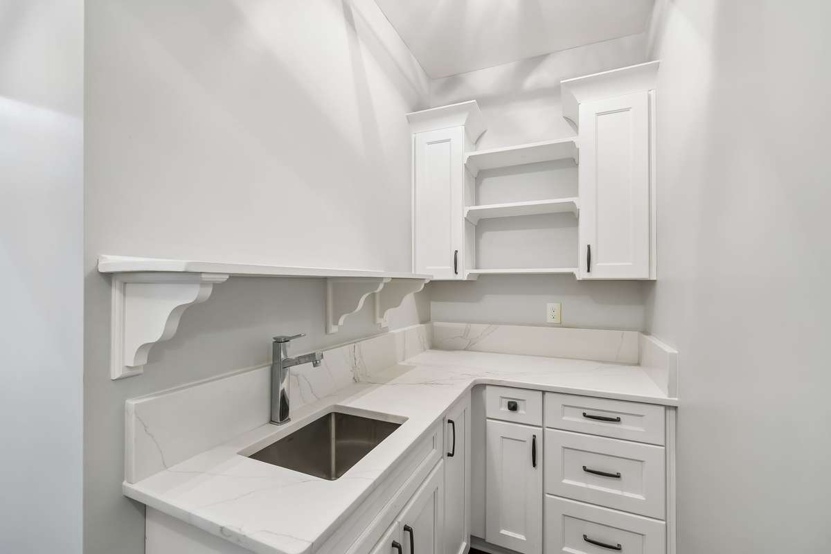 Spacious laundry room with sink.