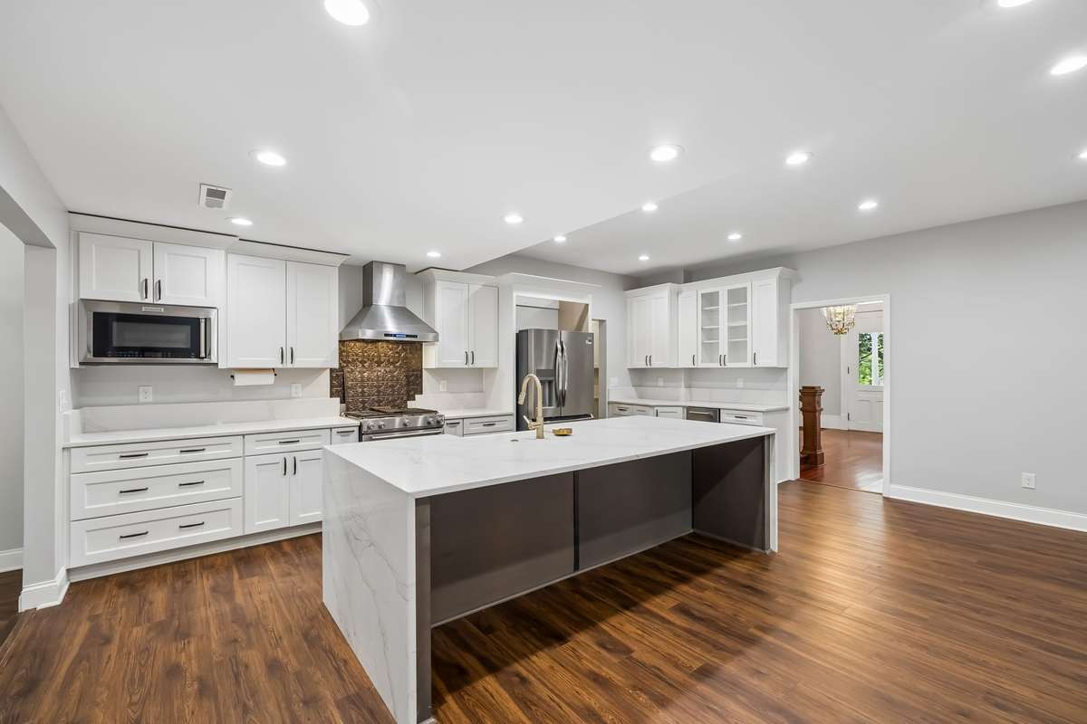 Let's get cooking! Gas cooktop, electric oven, stainless appliances, refrigerator, microwave, dishwasher, under counter ice maker. Large non-stainless chest freezer in the butlers pantry. Quartz countertops. Large island features a farmhouse sink.