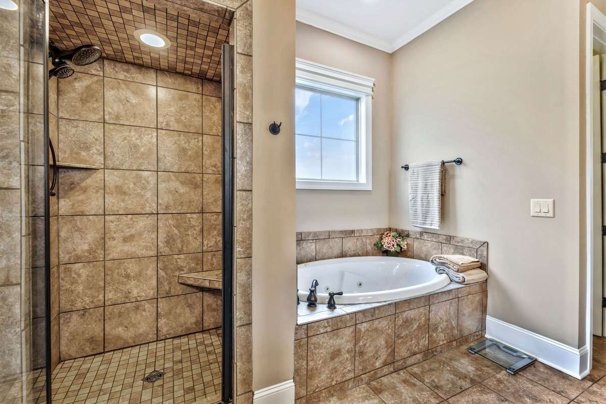 Primary bath walk—in shower and jacuzzi tub