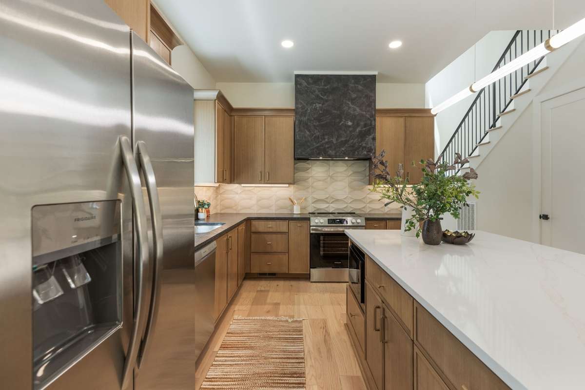 Large Kitchen, Stainless Appliances.  Large Hood with Glaze.