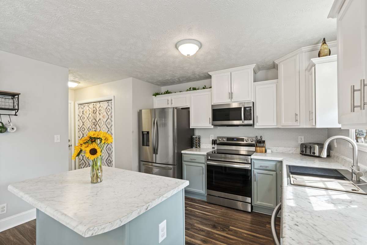 Kitchen has so much storage and prep space! Sink comes with cutting board and straining attachments