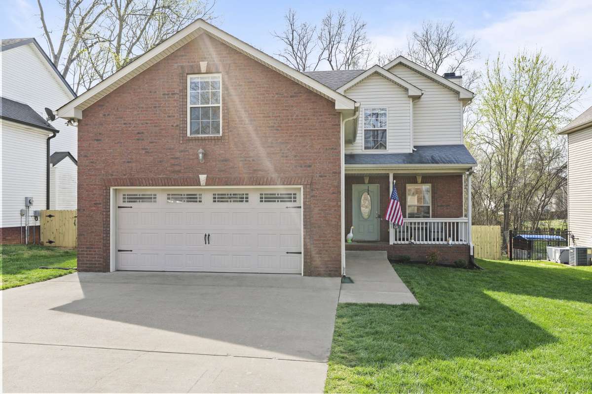 Welcome home! Enjoy the covered front porch and lush green lawn