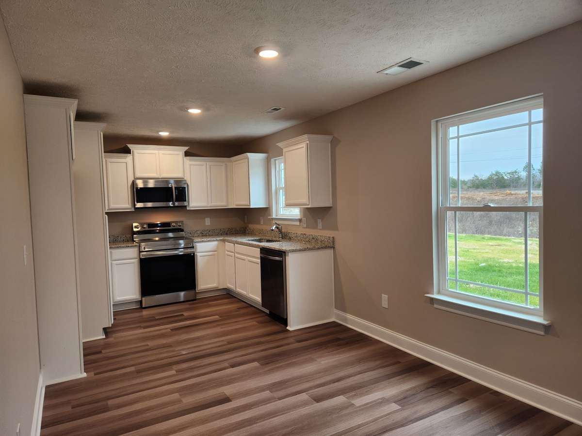 Kitchen is open to the Dining Area.  Picture of Previous House.