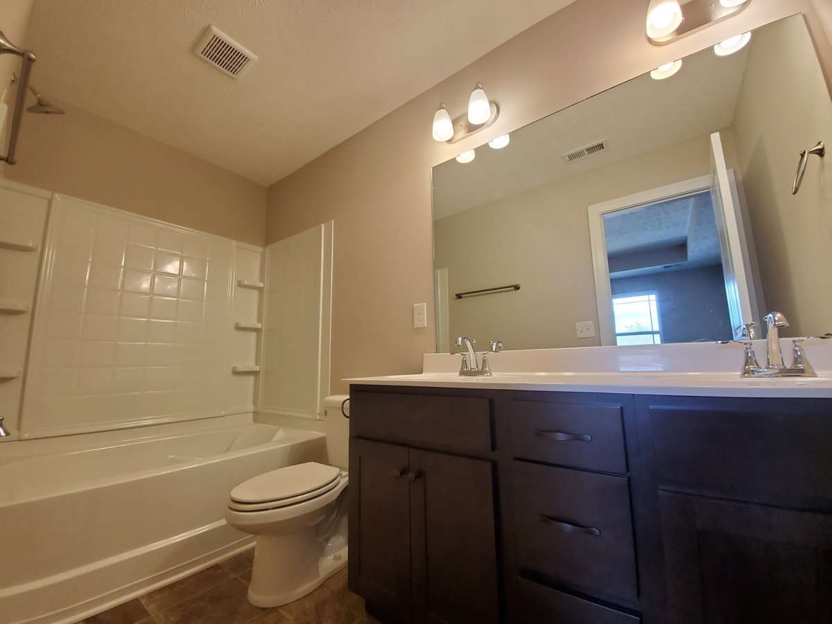 Primary Bathroom with Custom Cabinet and 2 Sinks.  Picture of Previous House.