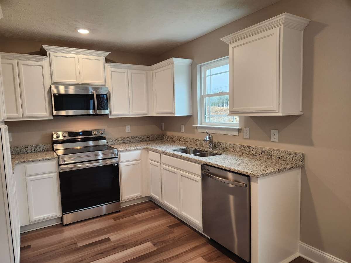 Kitchen will feature Brown Cabinets and Stainless Appliances. 
Picture of Previous House.