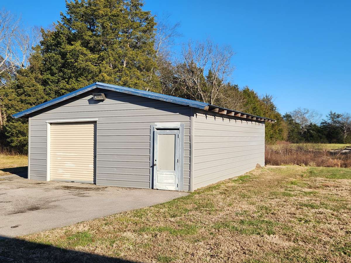 Detached Garage with Electricity provides Extra Space for Workshop and Storage.