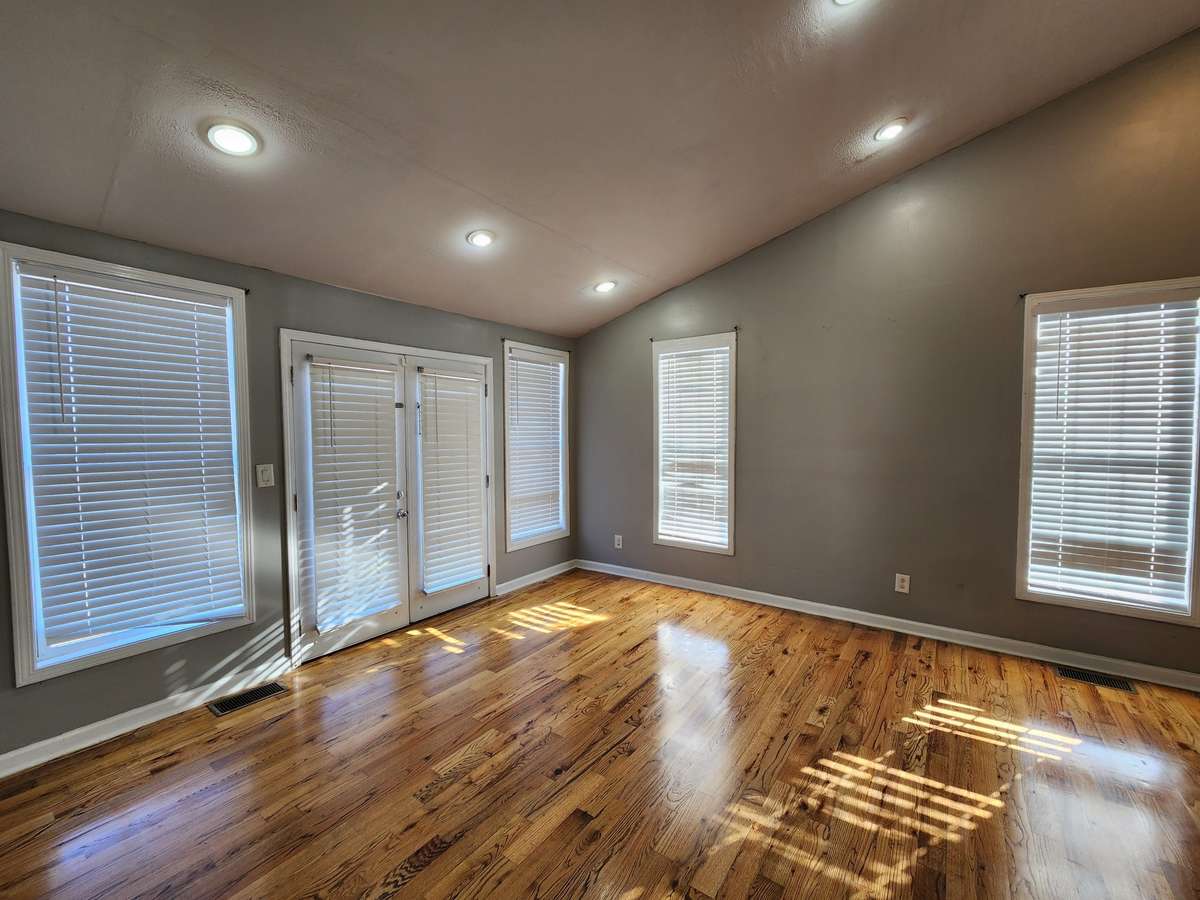 Spacious Primary Bedroom has a Vaulted Ceiling and Hardwood Floors.