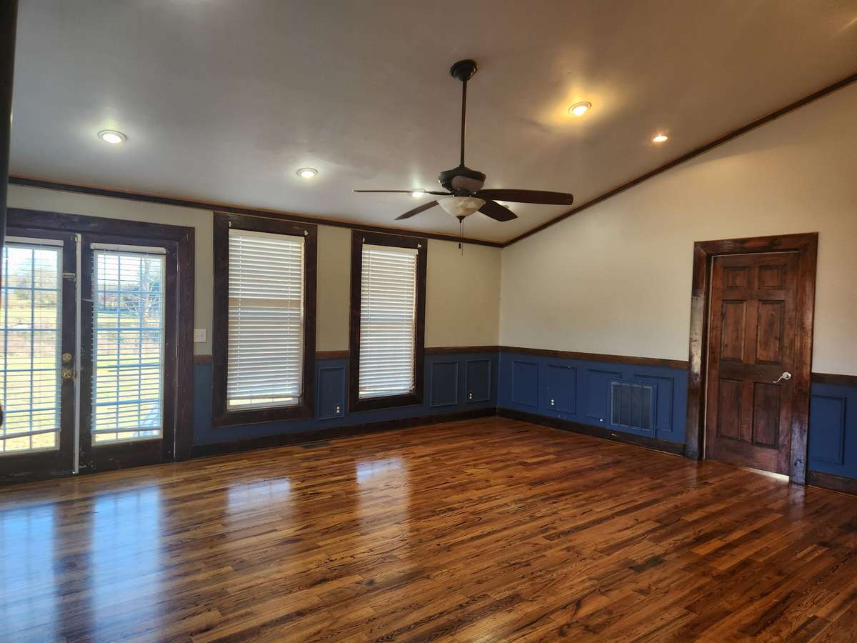 Spacious Living Room with Vaulted Ceiling and Hardwood Floors.
