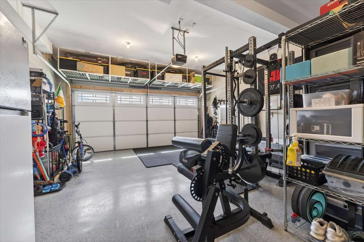 The garage has epoxy flooring, perfect for a home gym