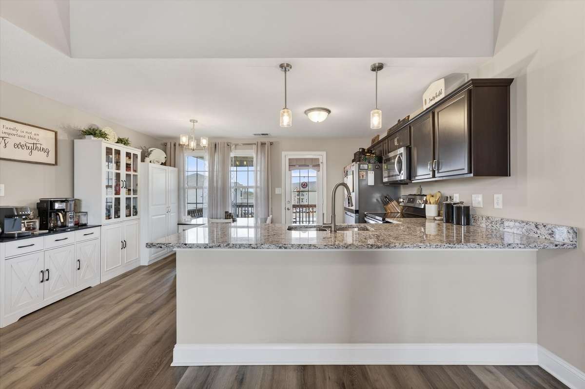 The kitchen has an island that can seat up to four chairs