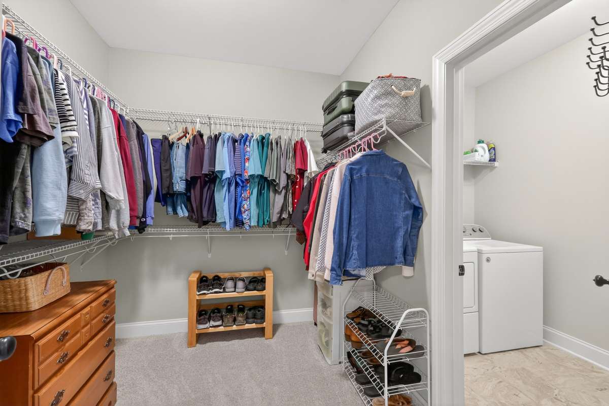 Spacious walk-in closet with adjacent laundry room on main floor