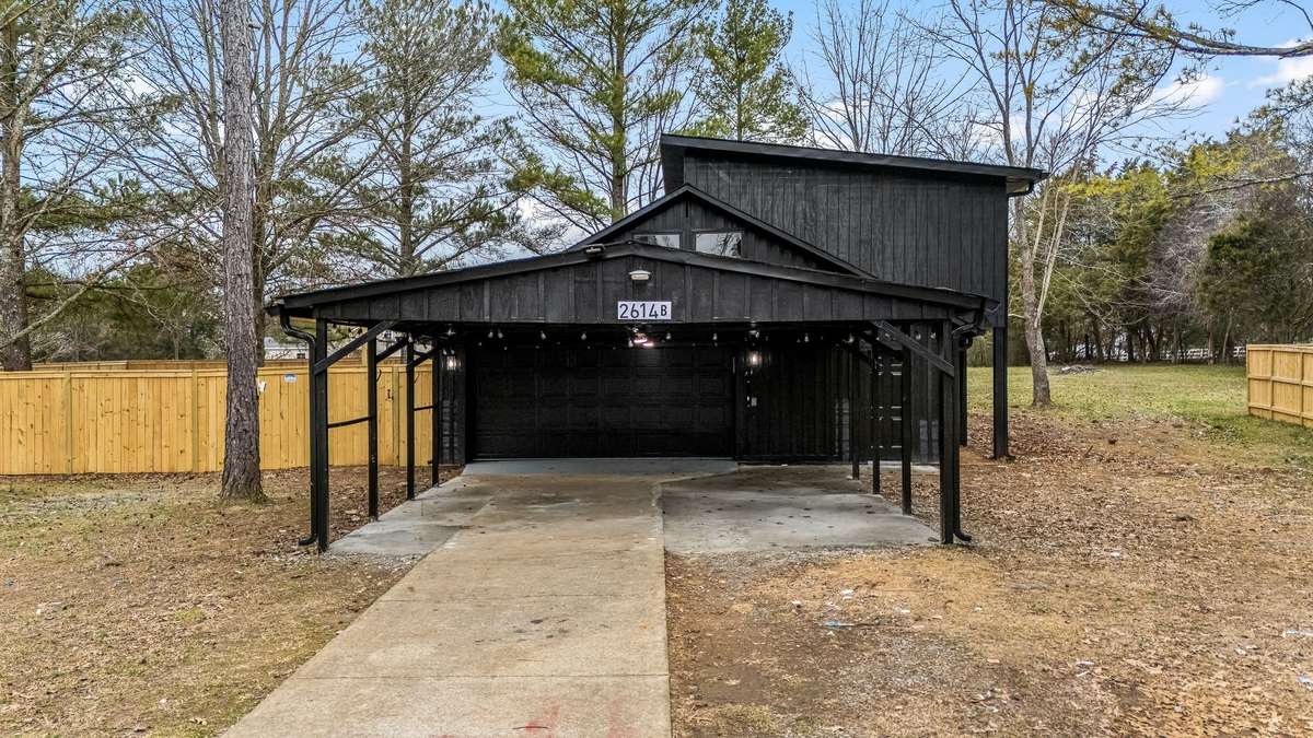 This is the detached 2 car garage with shop or storage room inside+ 2 car covered carport. The apartment is accessible through the garage or through the fence.