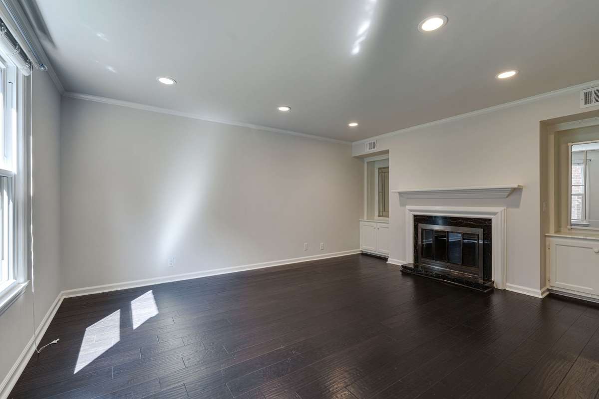 Spacious living room featuring sleek puck lighting