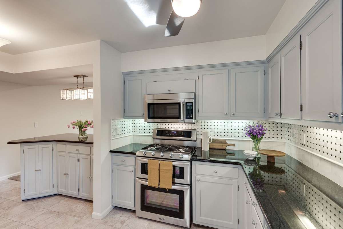 The kitchen has a peninsula for added storage, food serving and casual dining