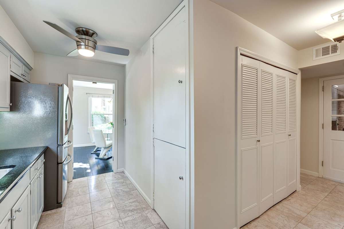 The two stacked doors house a super convenient pantry for all your storage needs -- the other set of double doors are to the laundry closet