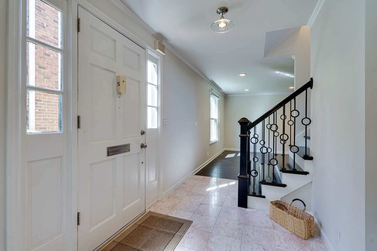 Another view showing the foyer centered between the formal living room and dinging room