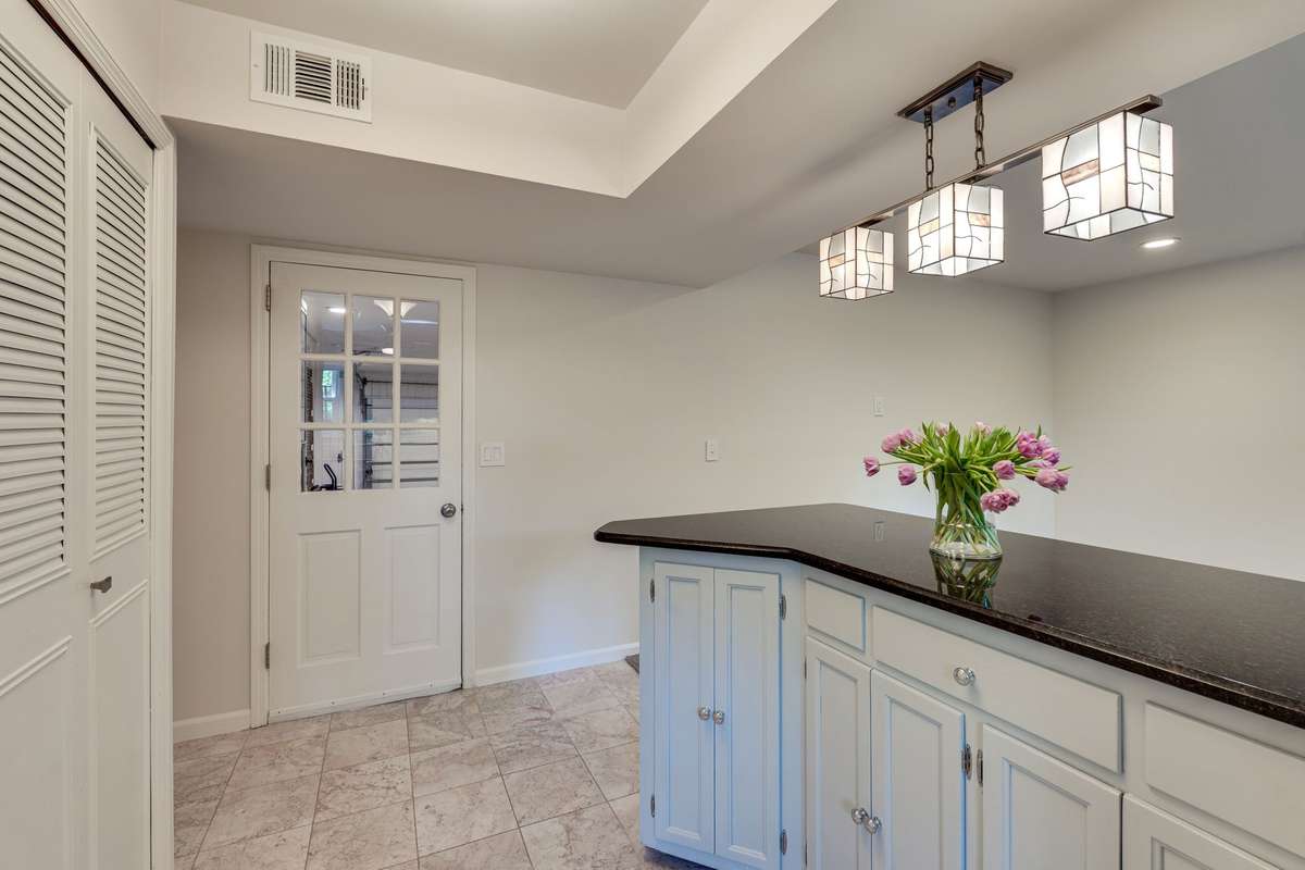 Another view of the kitchen peninsula that connects the kitchen to the den -- that side door is to the 2-car attached garage