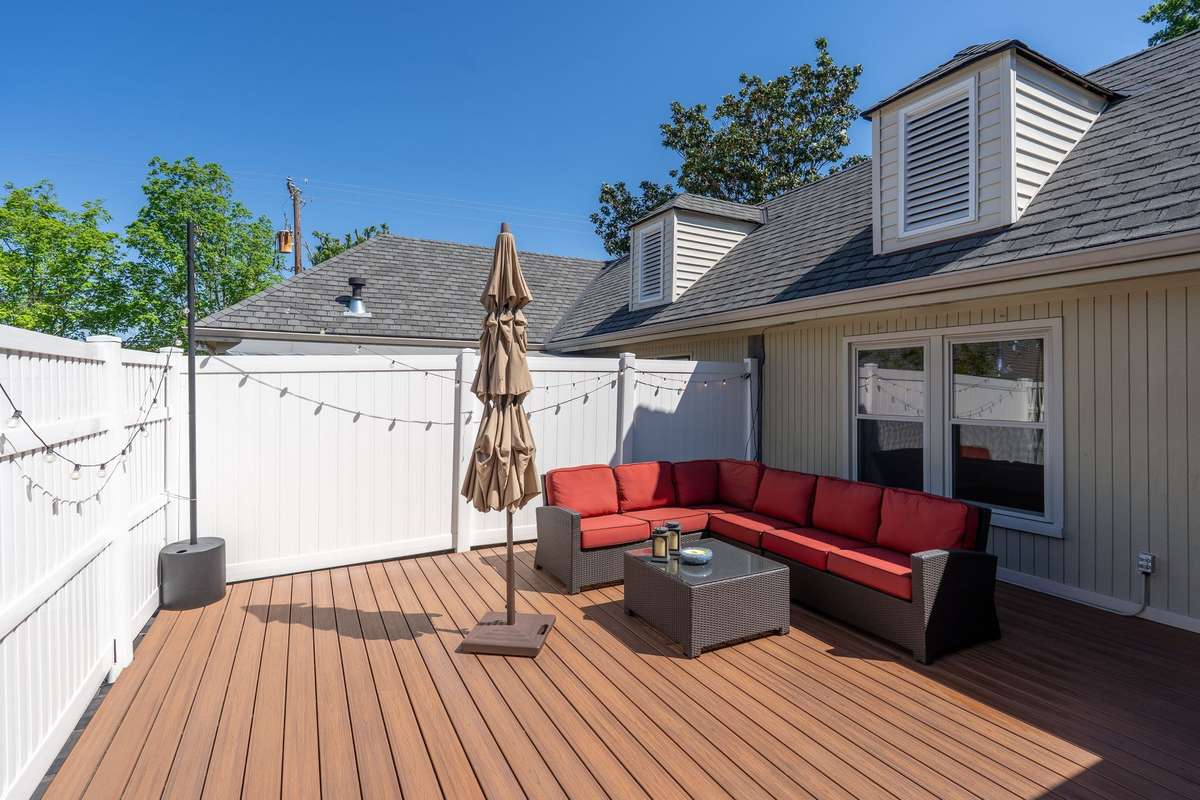 The deck features a privacy fence and Trex flooring for style and performance