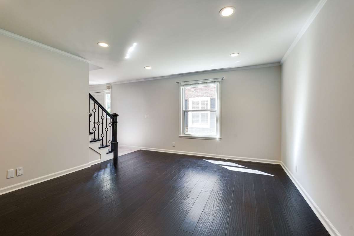 Another view of the living room showcasing the beautiful hardwood floors