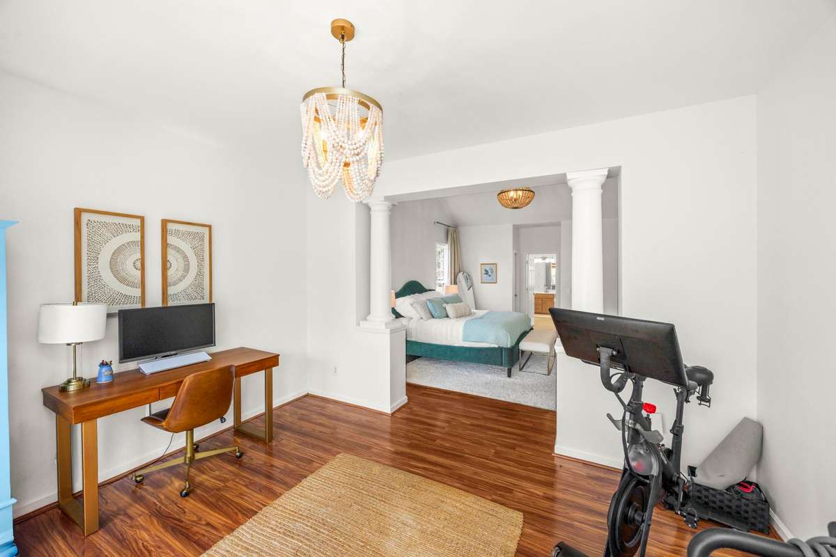 Private area off the primary bedroom that's currently used as an office & gym.