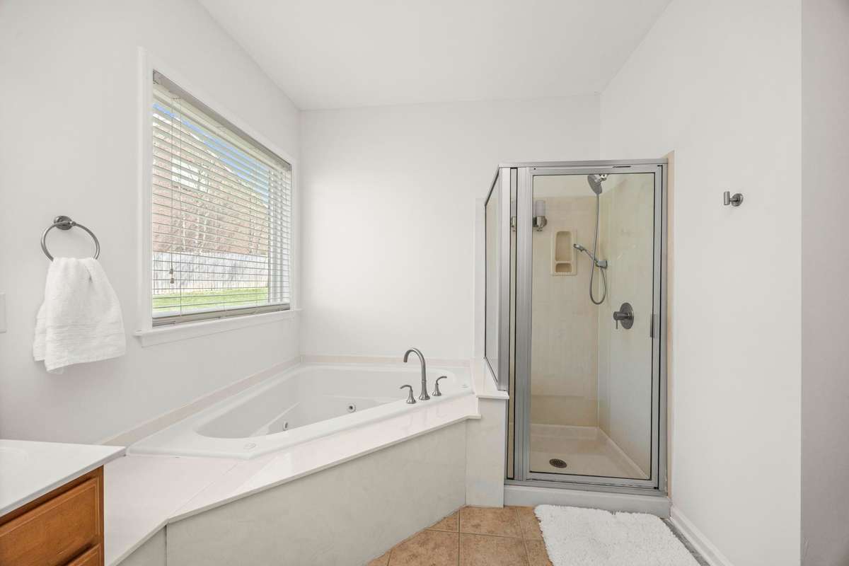 Primary bathroom with double vanities and gigantic tub & shower