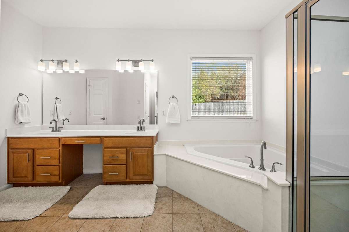 Primary bathroom with double vanities and gigantic tub & shower