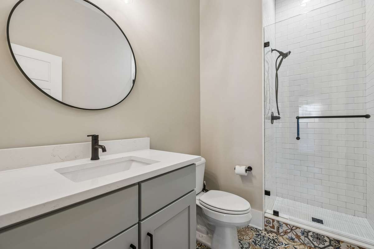 This full bath is accessible from the back patio and garage making it a great wet space if you were to build a pool!