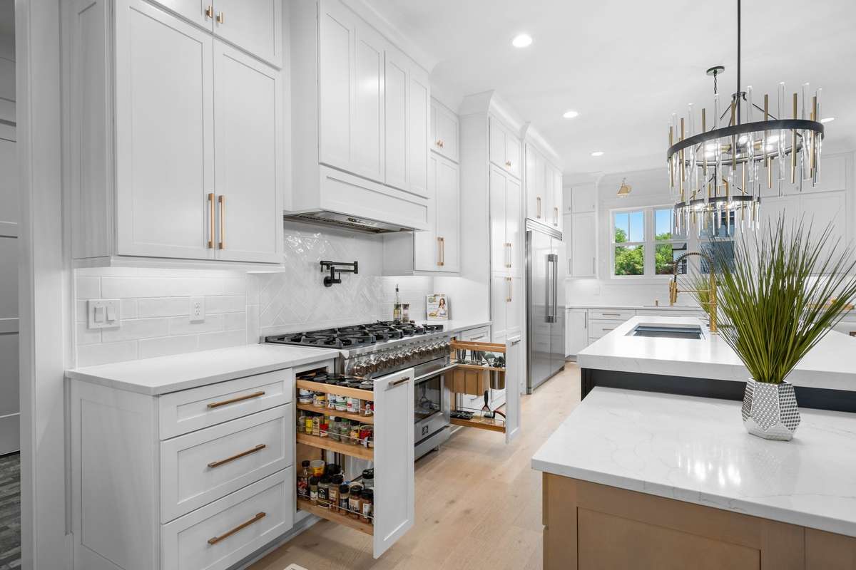 Premium 48” gas range with pot filler, quartz countertops, and abundant cabinetry for elevated everyday living.