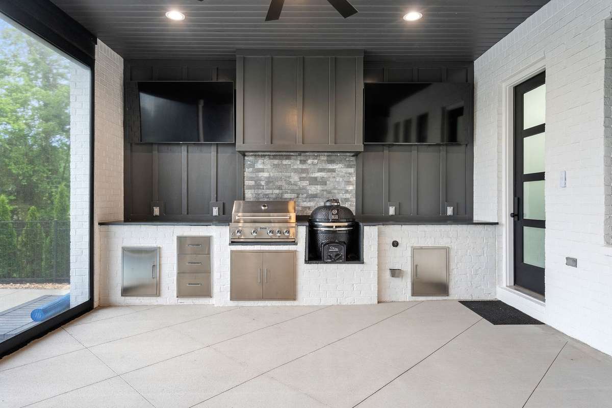 Fully equipped outdoor kitchen with built-in grill, smoker, and prep station.