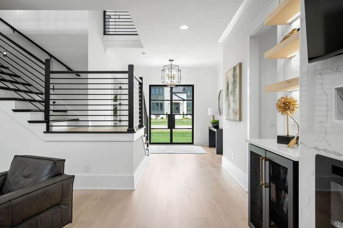 Striking entry with Iron Lion door, clean lines, and contemporary architectural detail. The flooring in this home is a statement in itself..clean and most complimentary to the contemporary feel of this home.