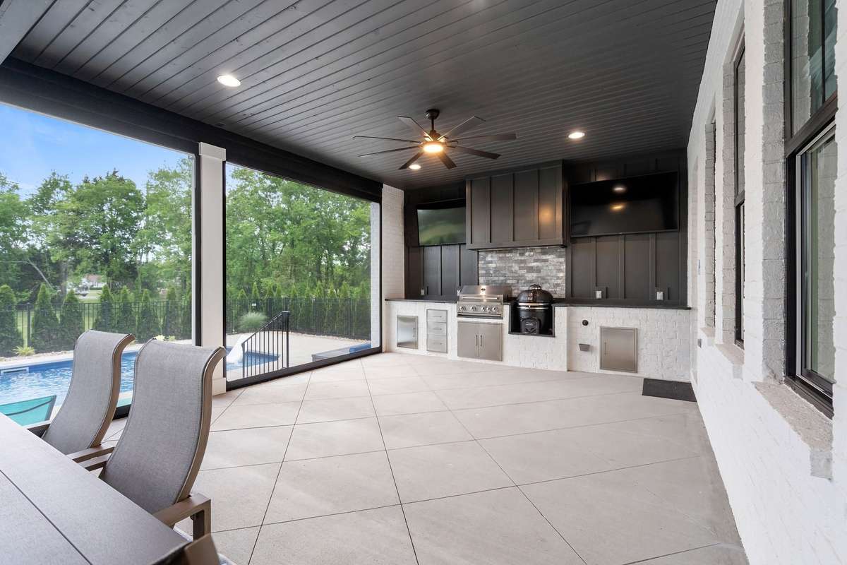 Resort-style covered patio overlooking private backyard and pool—perfect for year-round enjoyment.